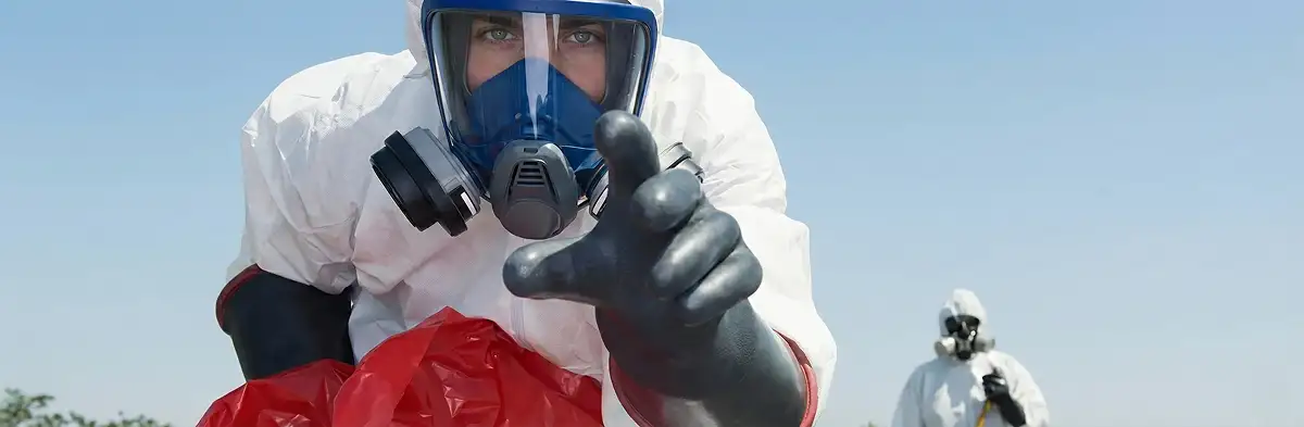 sewage clean up technician wearing protective gear handling biohazard materials in Boca Raton, FL
