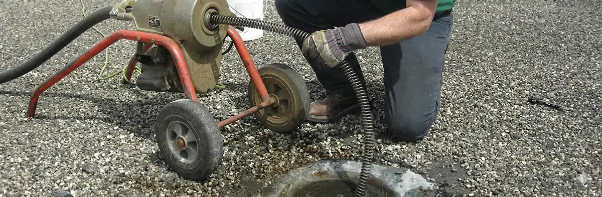 sewer rodding technician actively removing blockages from a sewer line in Boca Raton, FL